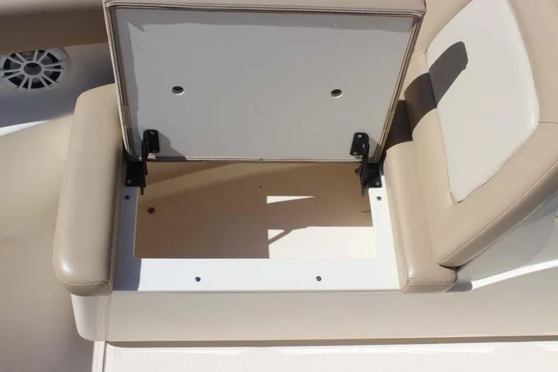 Slide: The Image of 2021 Scout 195 Sport Dorado boat interior with beige seating and motor. - 21