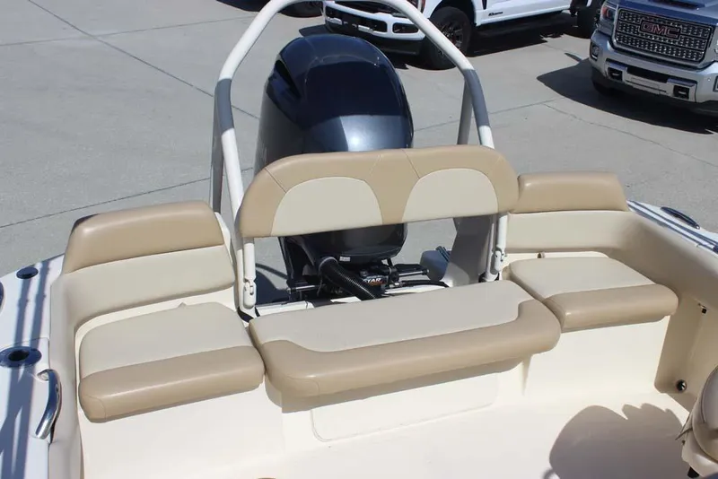 Slide: The Image of 2021 Scout 195 Sport Dorado boat interior with beige seating and steering wheel. - 22