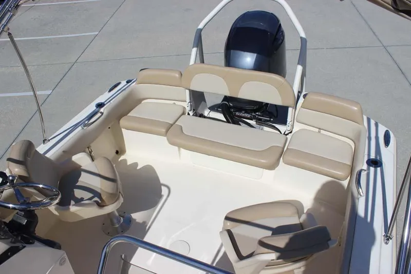 Slide: The Image of 2021 Scout 195 Sport Dorado boat interior with beige seating and storage compartment. - 23