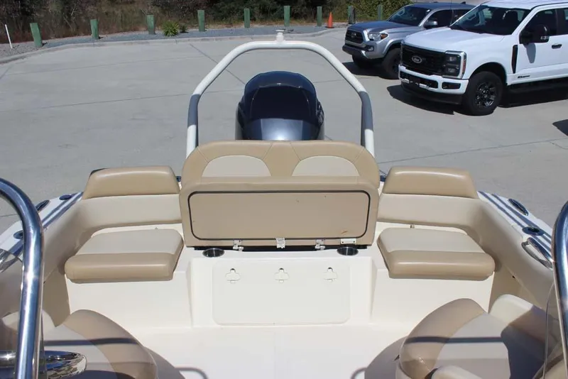 Slide: The Image of 2021 Scout 195 Sport Dorado boat with Yamaha 150 outboard motor, parked near trucks. - 25