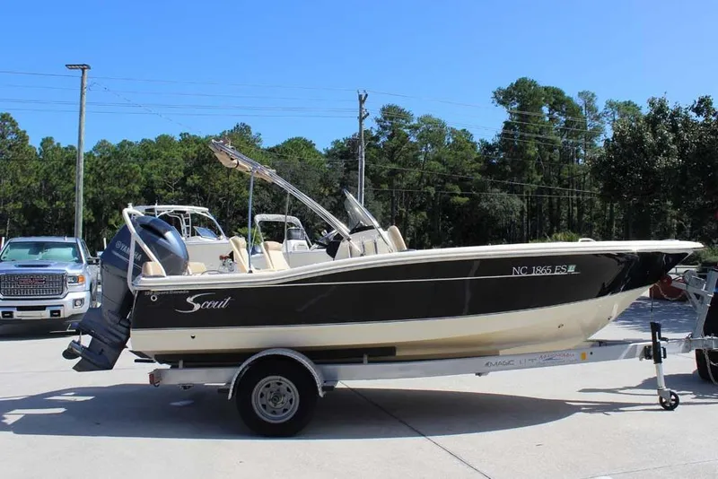 Slide: The Image of 2021 Scout 195 Sport Dorado boat with outboard motor in a parking lot. - 6