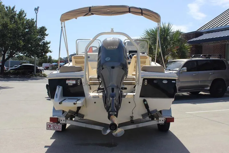 Slide: The Image of 2021 Scout 195 Sport Dorado boat covered, parked at SaltWater Marine dealership. - 7
