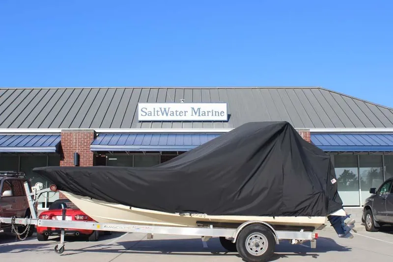 Slide: The Image of 2021 Scout 195 Sport Dorado boat dashboard with steering wheel and controls. - 8