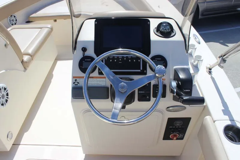Slide: The Image of Open storage compartment on a 2021 Scout 195 Sport Dorado boat, showing interior and control panel. - 9