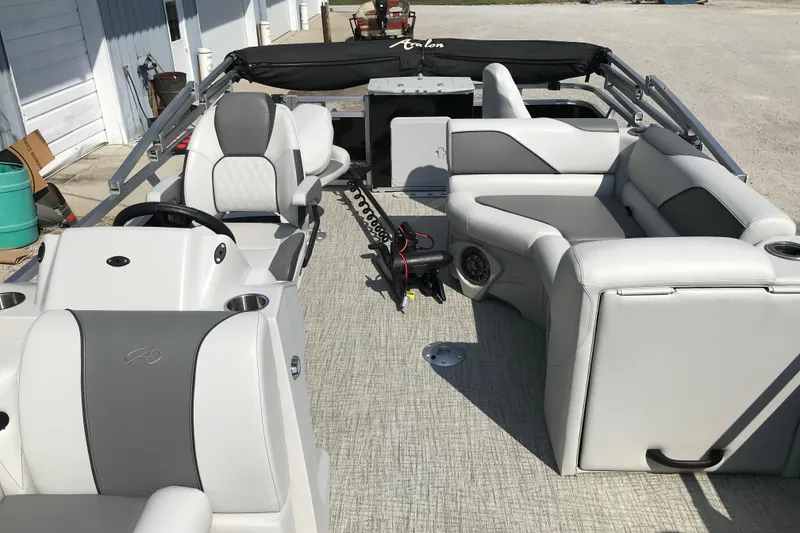 Slide: The Image of 2024 Avalon VENTURE FISH-N-CRUISE pontoon boat interior with gray seating and steering console. - 13
