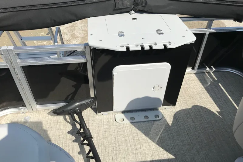 Slide: The Image of 2024 Avalon VENTURE FISH-N-CRUISE boat interior with storage compartment and fishing rod holder. - 22