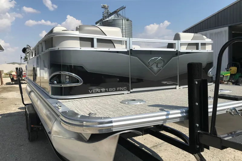 Slide: The Image of 2024 Avalon VENTURE FISH-N-CRUISE pontoon boat on trailer, outdoor setting. - 5