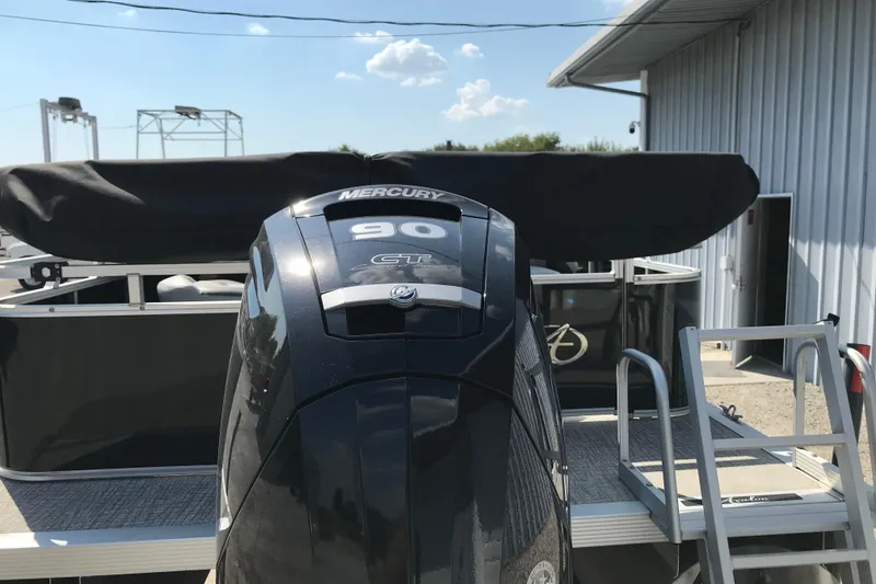 Slide: The Image of 2024 Avalon VENTURE FISH-N-CRUISE with Mercury 90 HP engine, docked near metal building. - 8