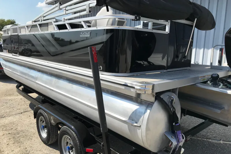 Slide: The Image of 2024 Avalon VENTURE FISH-N-CRUISE pontoon boat on trailer, sleek black design. - 9