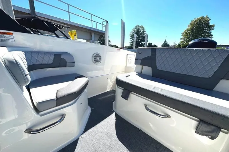 Slide: The Image of 2022 Bayliner VR6 Bowrider OB interior with gray seating, docked at marina. - 11