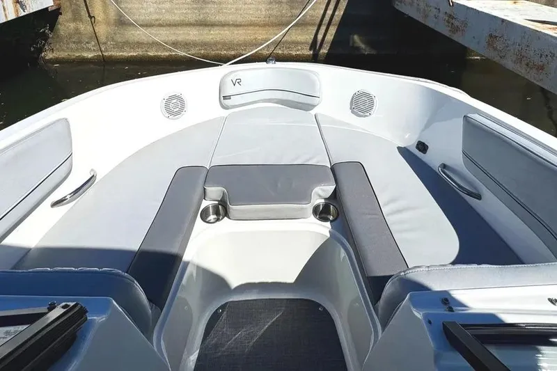 Slide: The Image of Storage compartment with red life jackets in a 2022 Bayliner VR6 Bowrider OB boat. - 15
