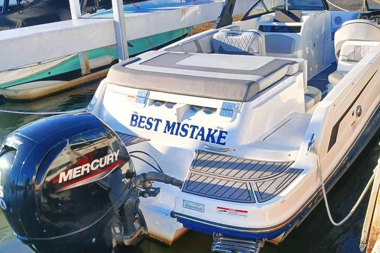 Slide: The Image of 2022 Bayliner VR6 Bowrider OB with Mercury outboard motor, docked on calm water. - 2