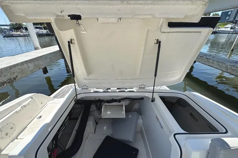 Slide: The Image of 2022 Bayliner VR6 Bowrider OB boat storage compartment open, showcasing interior space. - 21