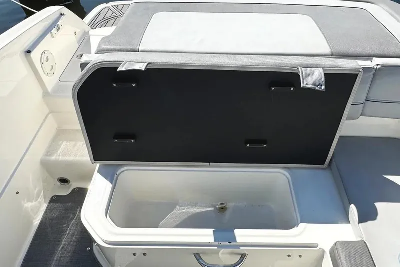 Slide: The Image of 2022 Bayliner VR6 Bowrider OB docked at a serene marina under clear blue skies. - 22