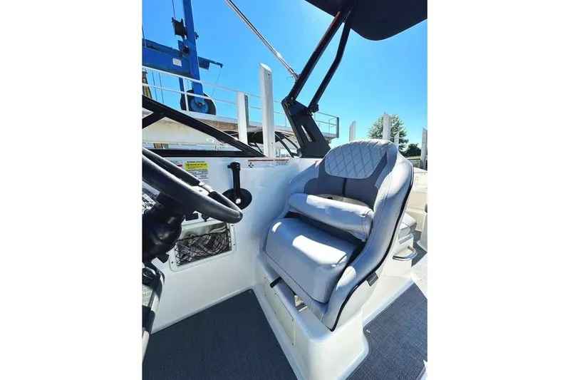 Slide: The Image of 2022 Bayliner VR6 Bowrider OB dashboard with steering wheel and gauges. - 4