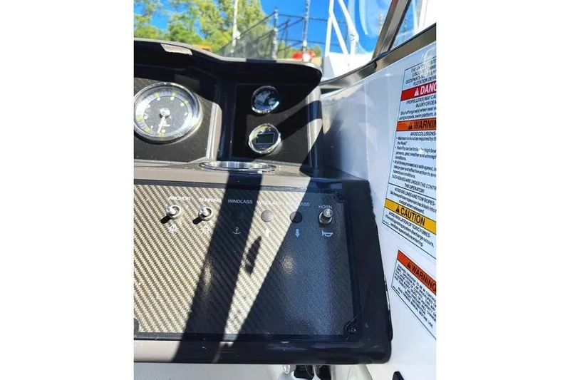 Slide: The Image of 2022 Bayliner VR6 Bowrider OB dashboard with control switches and gauges. - 7