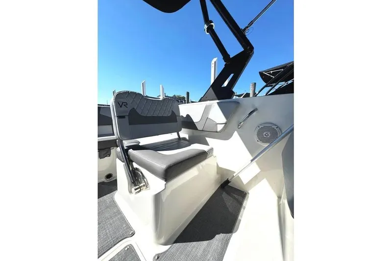 Slide: The Image of 2022 Bayliner VR6 Bowrider OB interior with dashboard and seating, docked at marina. - 9