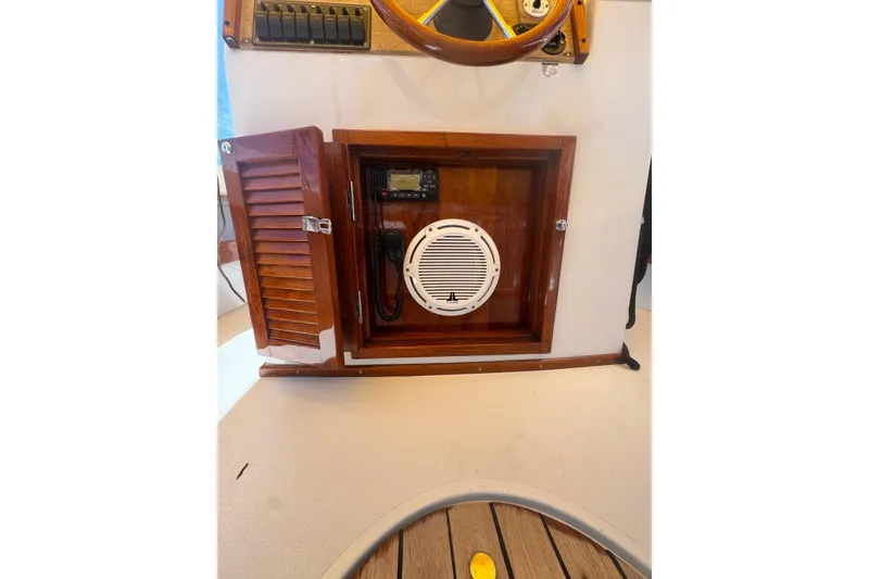 Slide: The Image of 1978 Formula boat dashboard with wooden panel, radio, and speaker. - 12