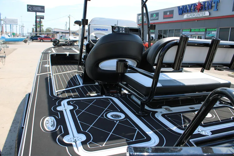 Slide: The Image of 2026 Mamba 227VX boat interior with sleek black and white design at dealership. - 10