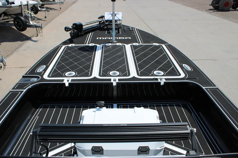 Slide: The Image of 2026 Mamba 227VX boat with sleek black deck design and modern features. - 17