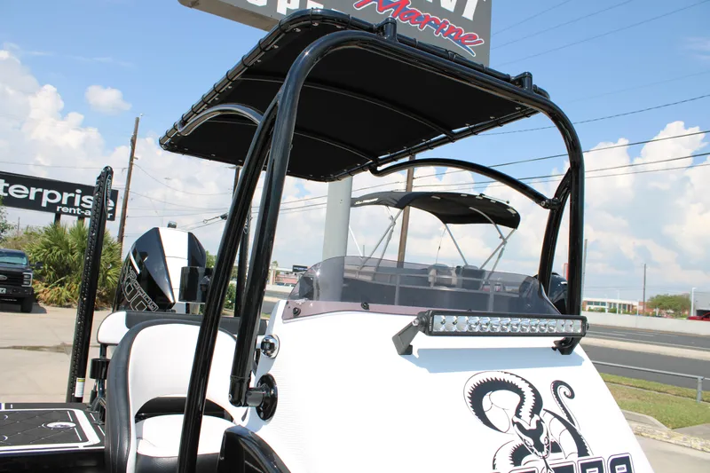 Slide: The Image of 2026 Mamba 227VX boat with T-top and LED light bar, parked outdoors. - 4