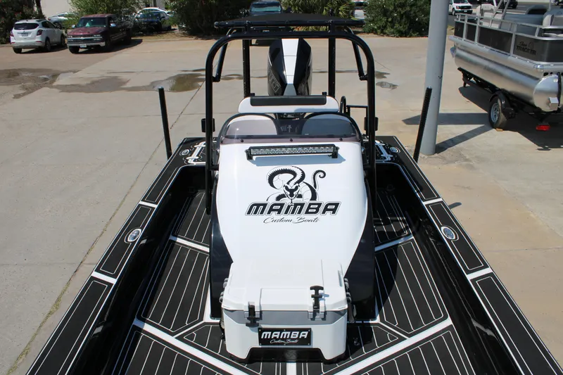 Slide: The Image of 2026 Mamba 227VX boat with sleek design and custom graphics, parked on a lot. - 8