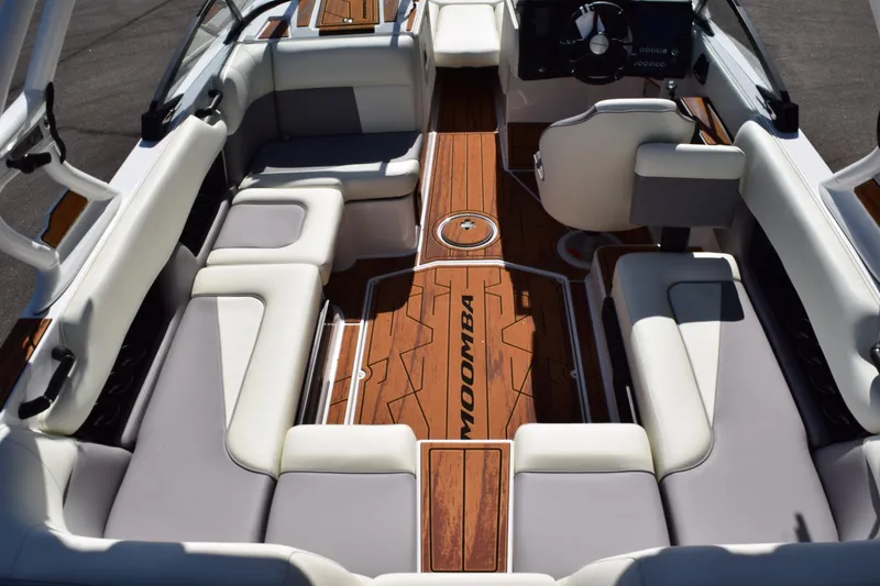 Slide: The Image of 2025 Moomba Craz boat interior with sleek seating and wood flooring. - 10