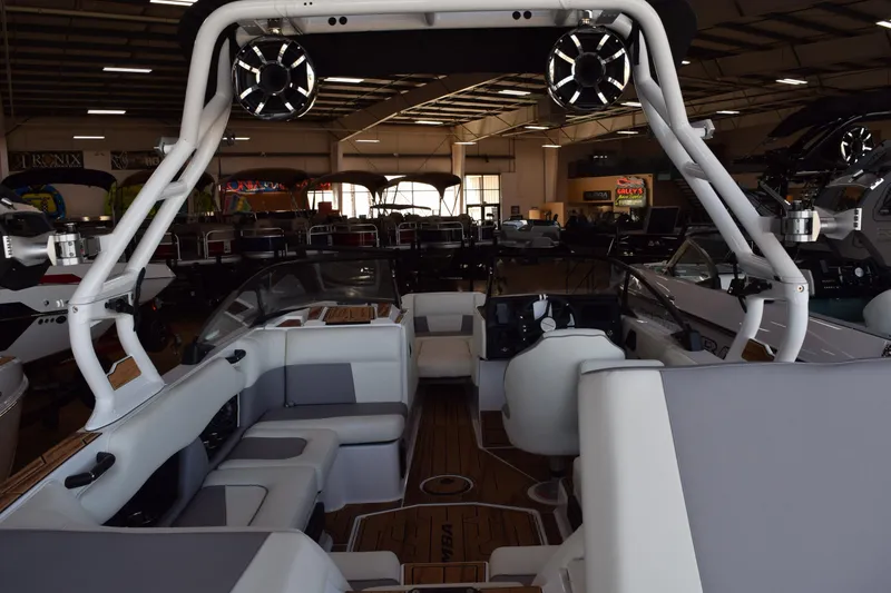 Slide: The Image of 2025 Moomba Craz boat interior with seating and sound system in showroom. - 12