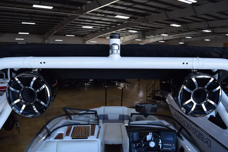 Slide: The Image of 2025 Moomba Craz boat interior with speakers and dashboard in a showroom. - 13