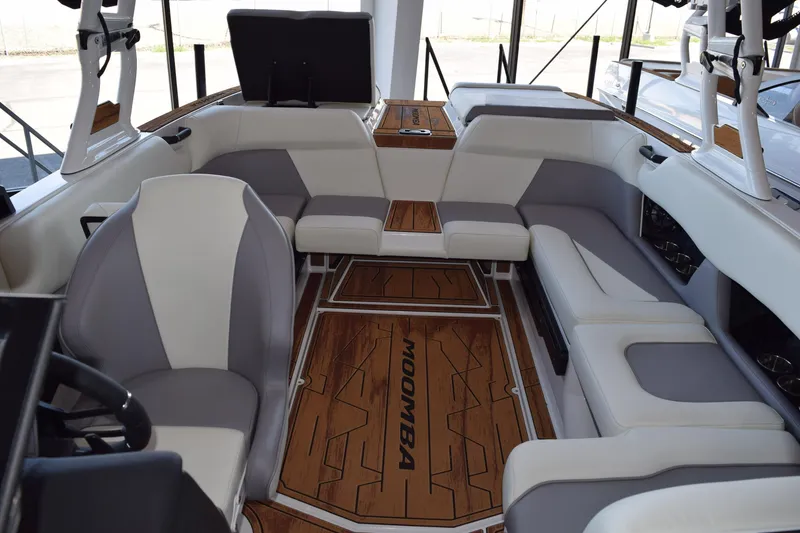 Slide: The Image of 2025 Moomba Craz boat interior with stylish seating and wood accents. - 16