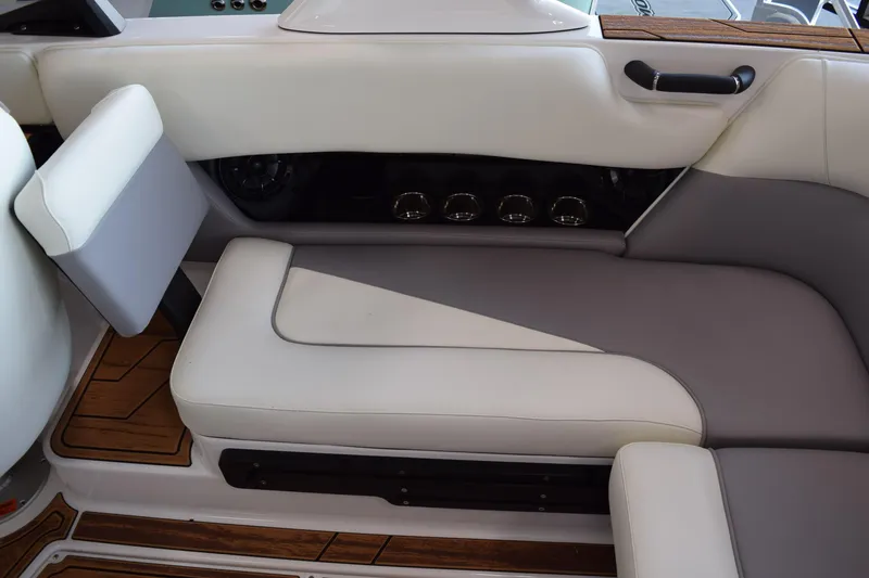 Slide: The Image of 2025 Moomba Craz boat interior with white and gray seating, wood accents. - 20