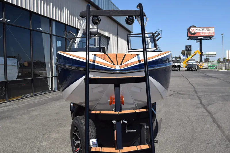 Slide: The Image of 2025 Moomba Craz boat on trailer, parked outside dealership. - 3