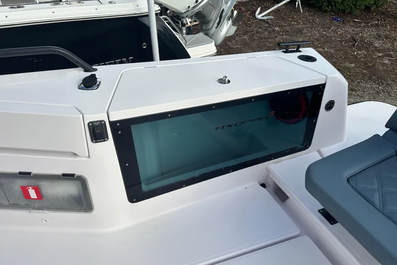 Slide: The Image of 2022 Axopar 37 Sun Top boat with open storage compartment on deck. - 10