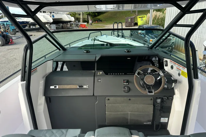 Slide: The Image of 2022 Axopar 37 Sun Top boat interior with open storage compartments. - 13