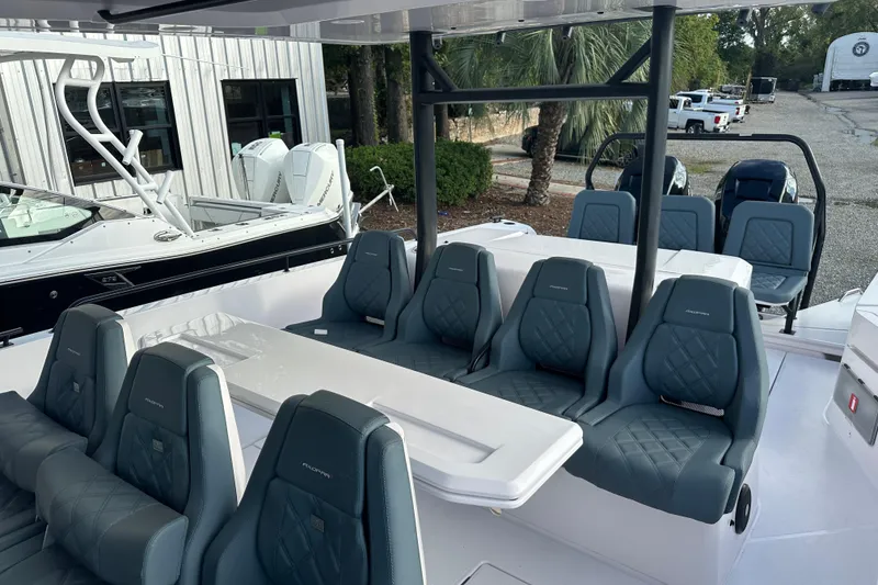 Slide: The Image of 2022 Axopar 37 Sun Top boat storage compartments open, showcasing spacious interior design. - 14