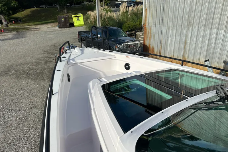 Slide: The Image of 2022 Axopar 37 Sun Top boat interior with seating and table on a sunny day. - 16