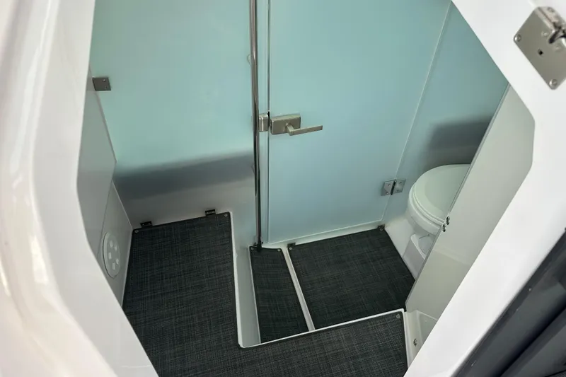 Slide: The Image of 2022 Axopar 37 Sun Top helm with navigation display and controls. - 20