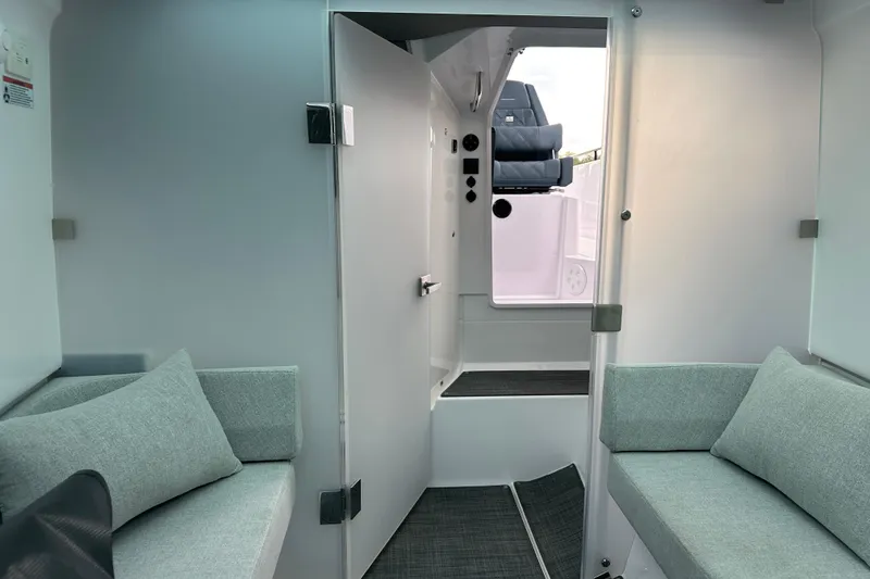 Slide: The Image of 2022 Axopar 37 Sun Top helm with advanced navigation displays and steering wheel. - 21