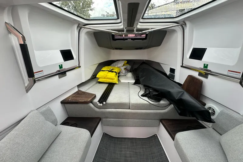 Slide: The Image of 2022 Axopar 37 Sun Top boat on calm water, featuring sleek design and spacious deck. - 22