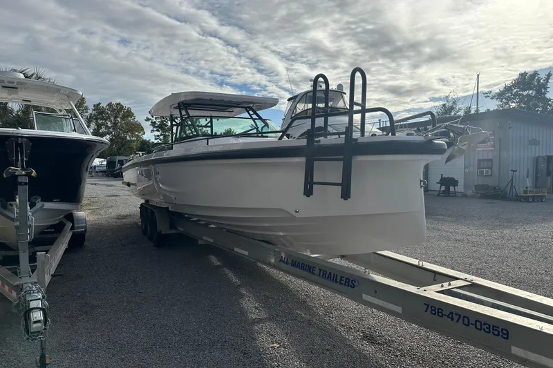 Slide: The Image of 2022 Axopar 37 Sun Top boat cruising on a river with scenic background. - 3