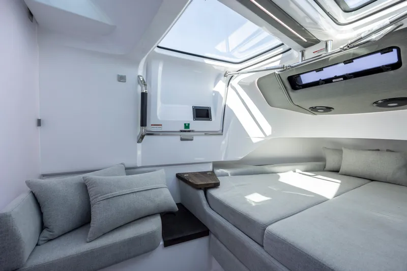 Slide: The Image of Luxurious interior of 2022 Axopar 37 Sun Top with modern seating and skylight. - 31