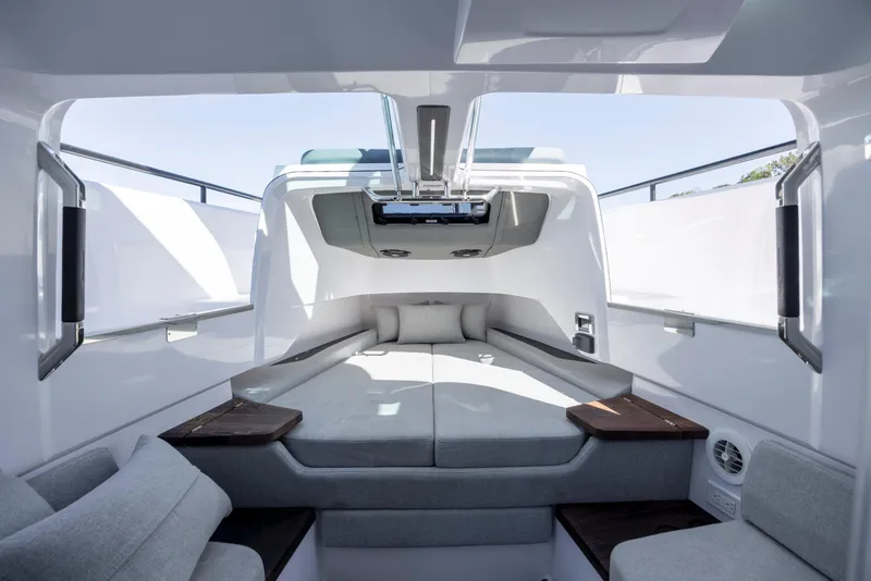 Slide: The Image of 2022 Axopar 37 Sun Top cabin interior with modern seating and sleek design. - 33
