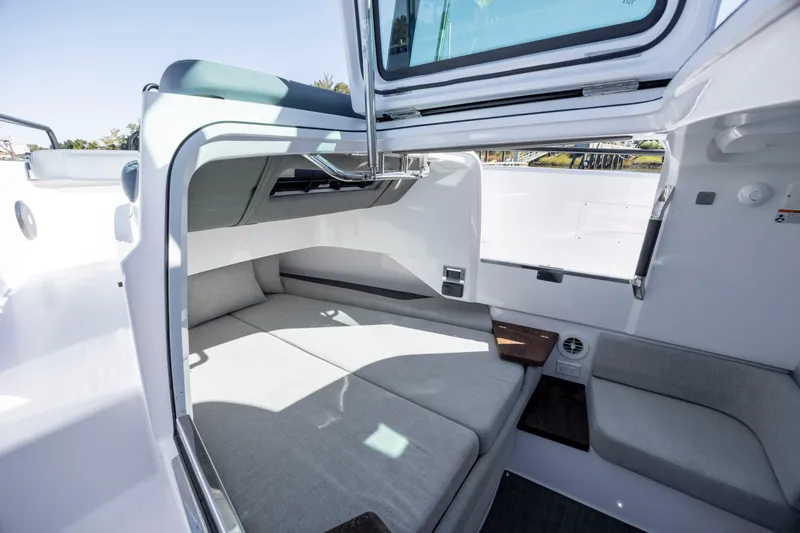 Slide: The Image of 2022 Axopar 37 Sun Top cabin interior with modern seating and sleek design. - 34