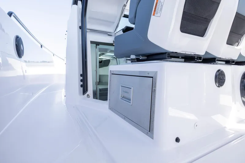 Slide: The Image of 2022 Axopar 37 Sun Top interior with seating and storage compartment. - 35