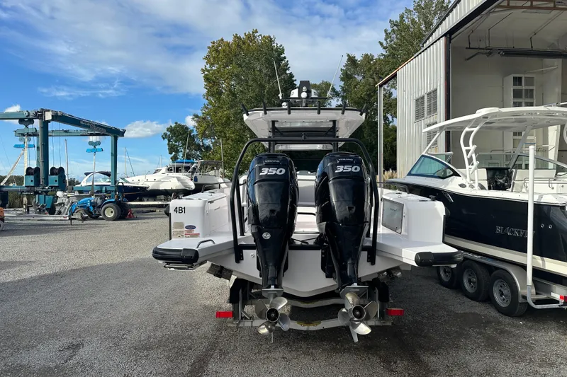 Slide: The Image of 2022 Axopar 37 Sun Top boat cruising on a calm river with forested background. - 6