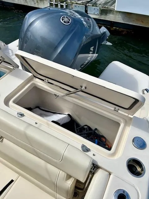 Slide: The Image of Open storage compartment on 2021 Grady-White Freedom 235 boat, with Yamaha outboard motor. - 12