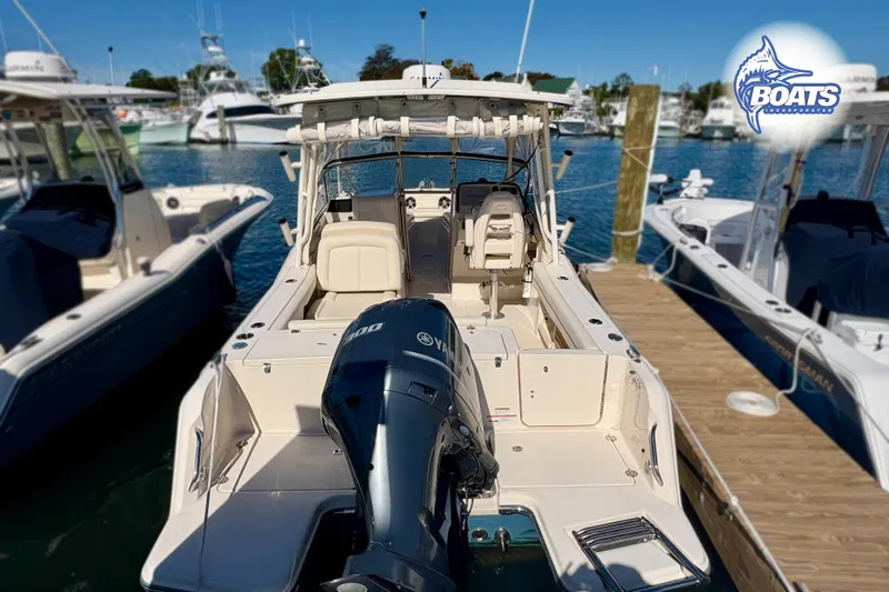 Slide: The Image of 2021 Grady-White Freedom 235 boat docked, featuring Yamaha outboard motor. - 15