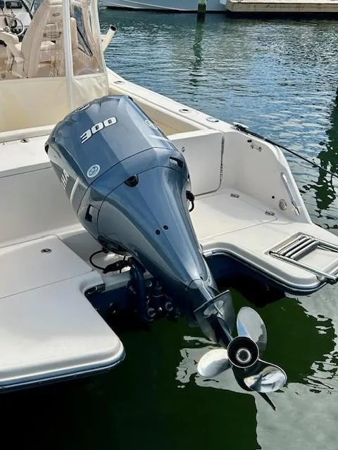 Slide: The Image of 2021 Grady-White Freedom 235 boat with powerful 300 HP outboard motor in marina. - 16