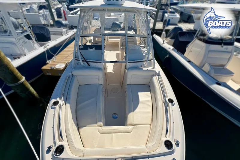 Slide: The Image of 2021 Grady-White Freedom 235 boat docked, showcasing spacious seating and sleek design. - 3