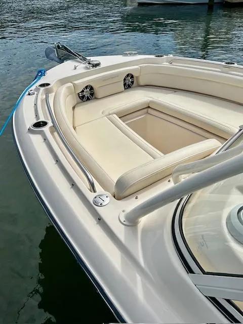 Slide: The Image of 2021 Grady-White Freedom 235 boat with spacious seating, docked on calm water. - 4